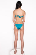 Load image into Gallery viewer, Model wearing Ataya Reversible Tie Side Pant in Teal / Dusty Rose
