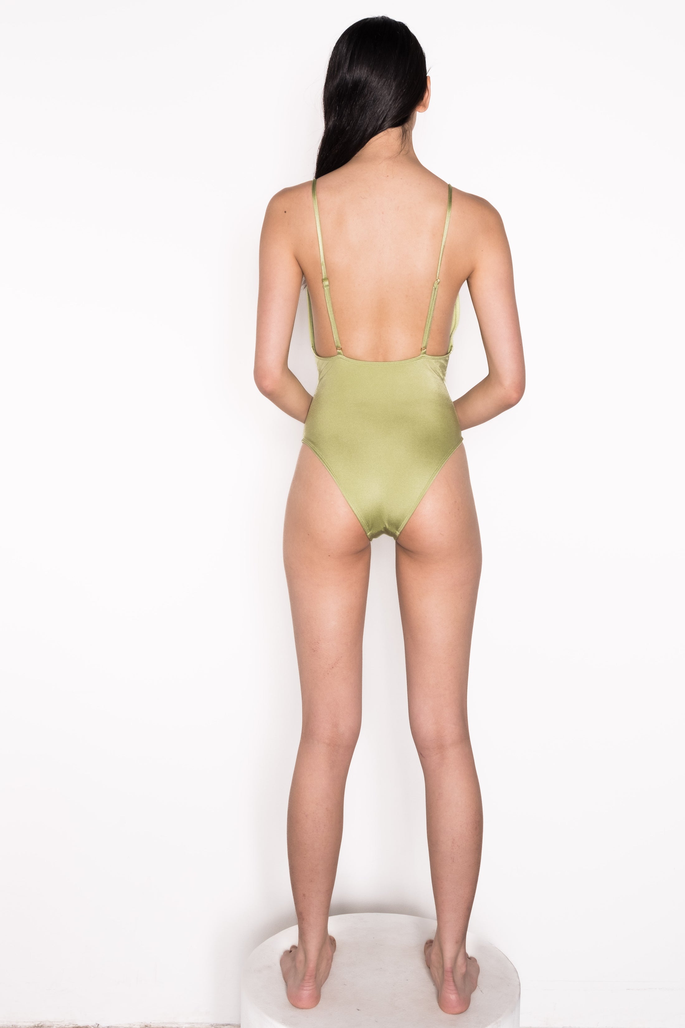 Model wearing Ataya Low V Neck One Piece Swimsuit  in Green Leaf